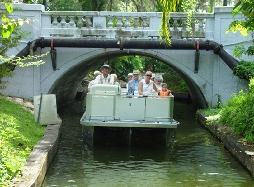 RIders enjoying a trip on Winter Park Boat Tour beneath bridge