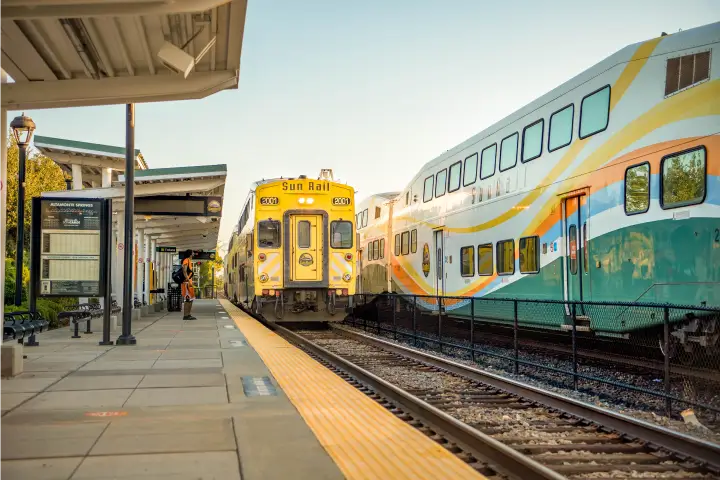 Passenger waits on the platform at the SunRail Altamonte Springs Station as train pulls into station.