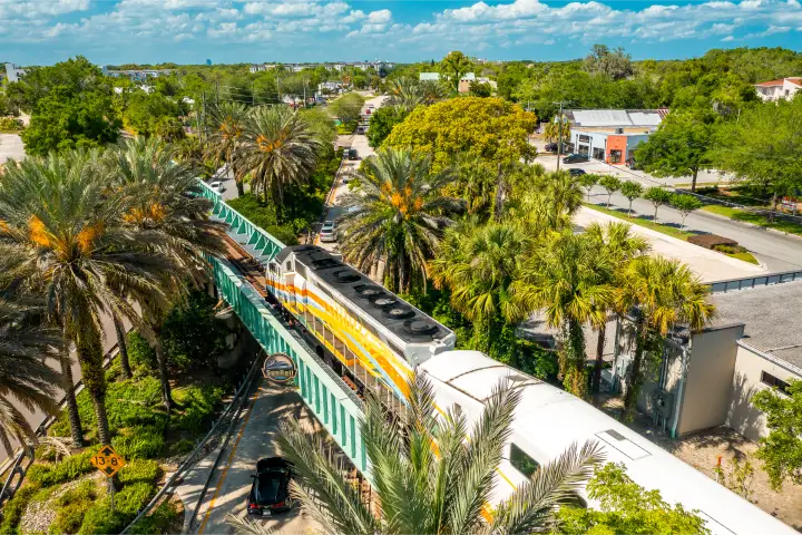 SunRail Train travels on a bridge as it crosses over a highway in Winter Park, FL.