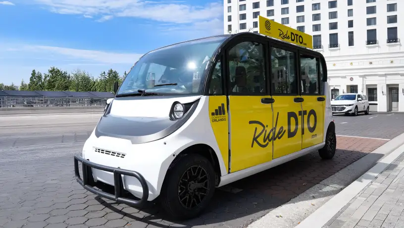 RideDTO vehicle parked at a city curb.