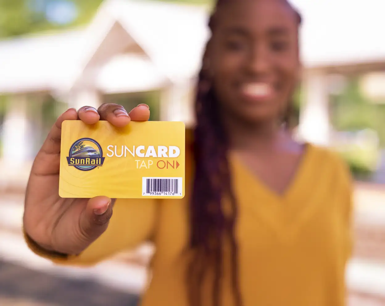 Woman holding a legacy yellow SunCard.