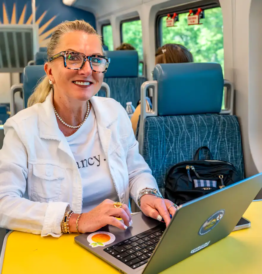 SunRail passholder using her computer on a SunRail train.