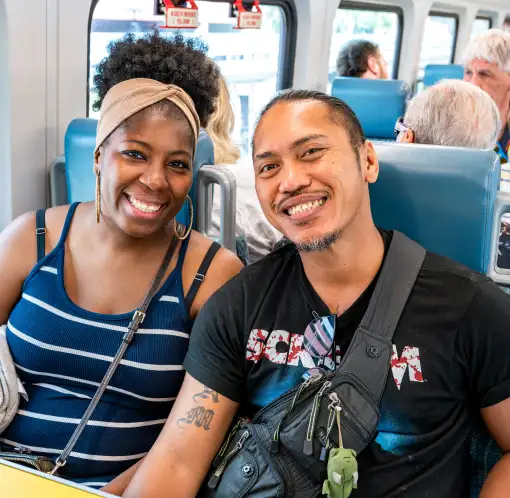 A female and male passenger on board a SunRail train.